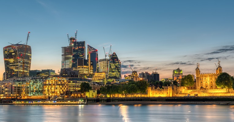 AI leadership roles explained: the City of London skyline and the Tower of London at dusk across the Thames